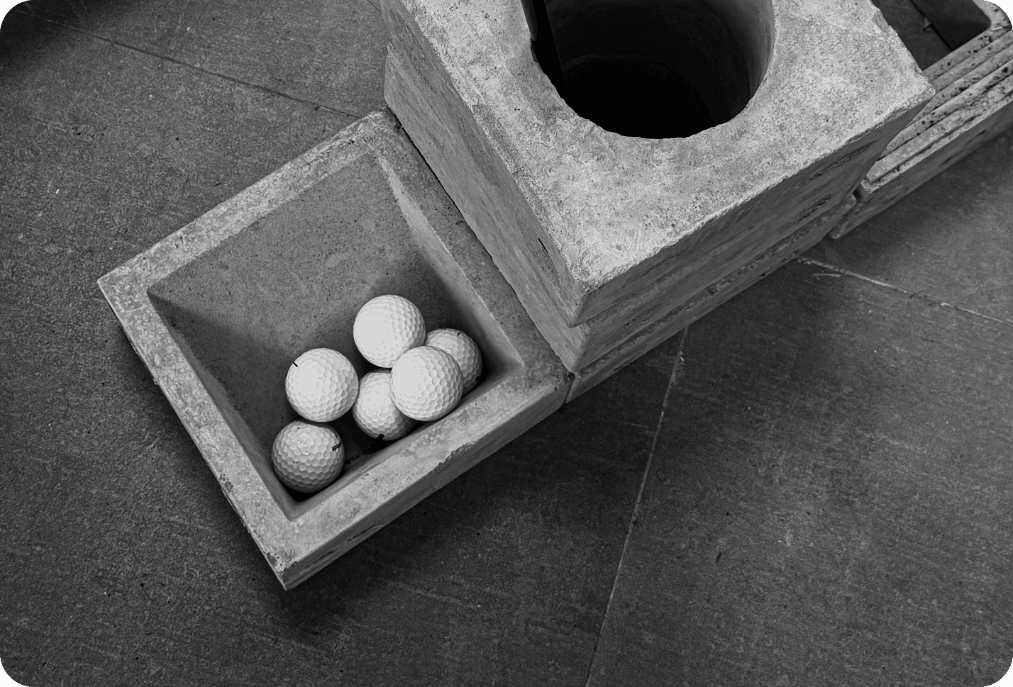 A wooden box of golf balls